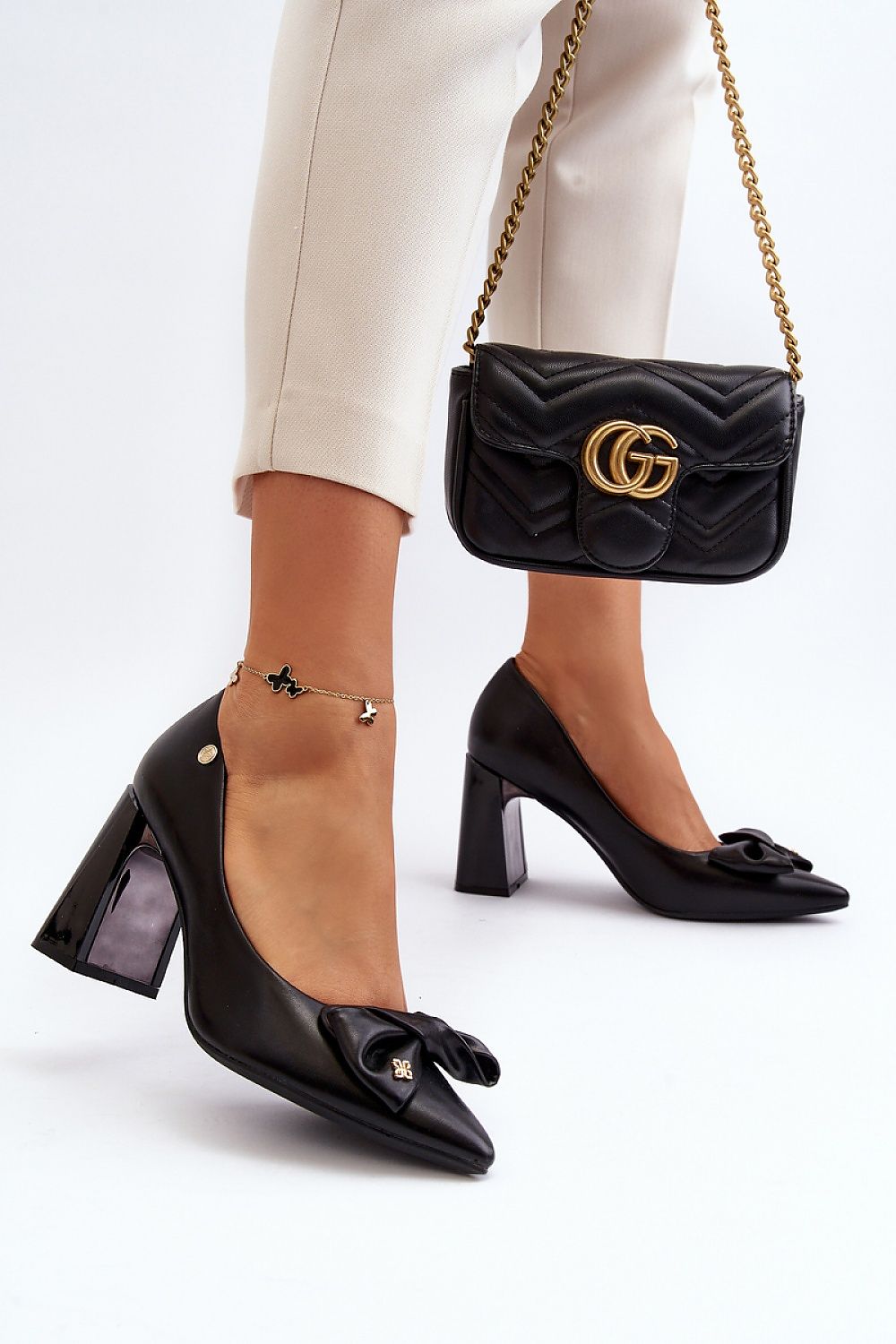 “Emblem Bow Block Heel Shoe in Black, angled view”