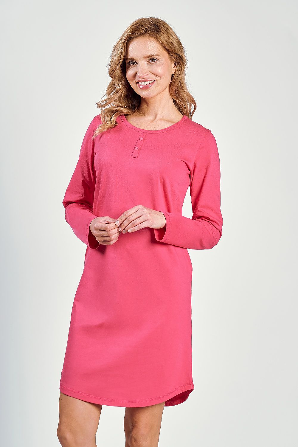 Woman wearing a pink dress against a white background