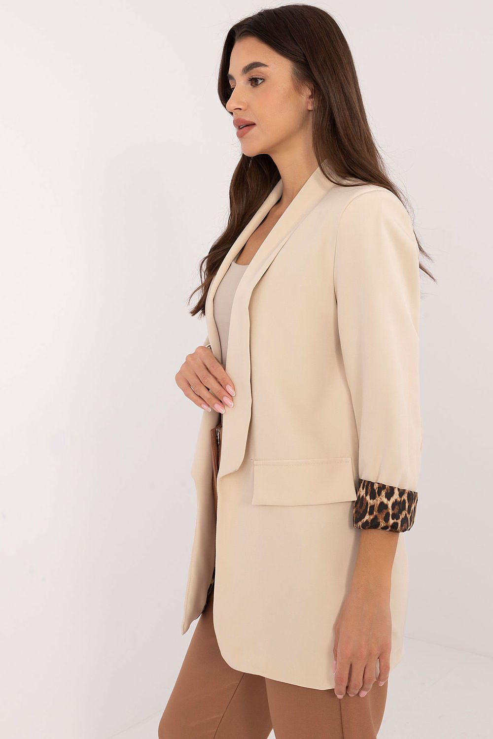 Side view highlighting smooth texture and lined interior of beige Elise jacket.