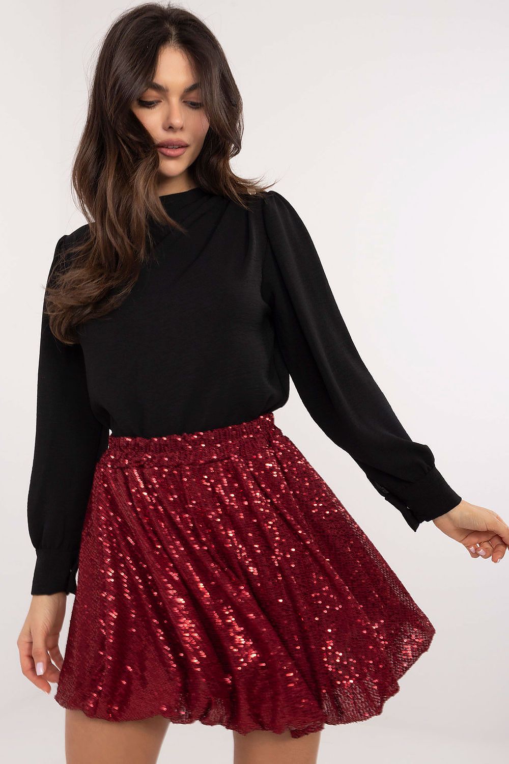 Full view of sequin bomb mini skirt highlighting bomb silhouette and mini length.