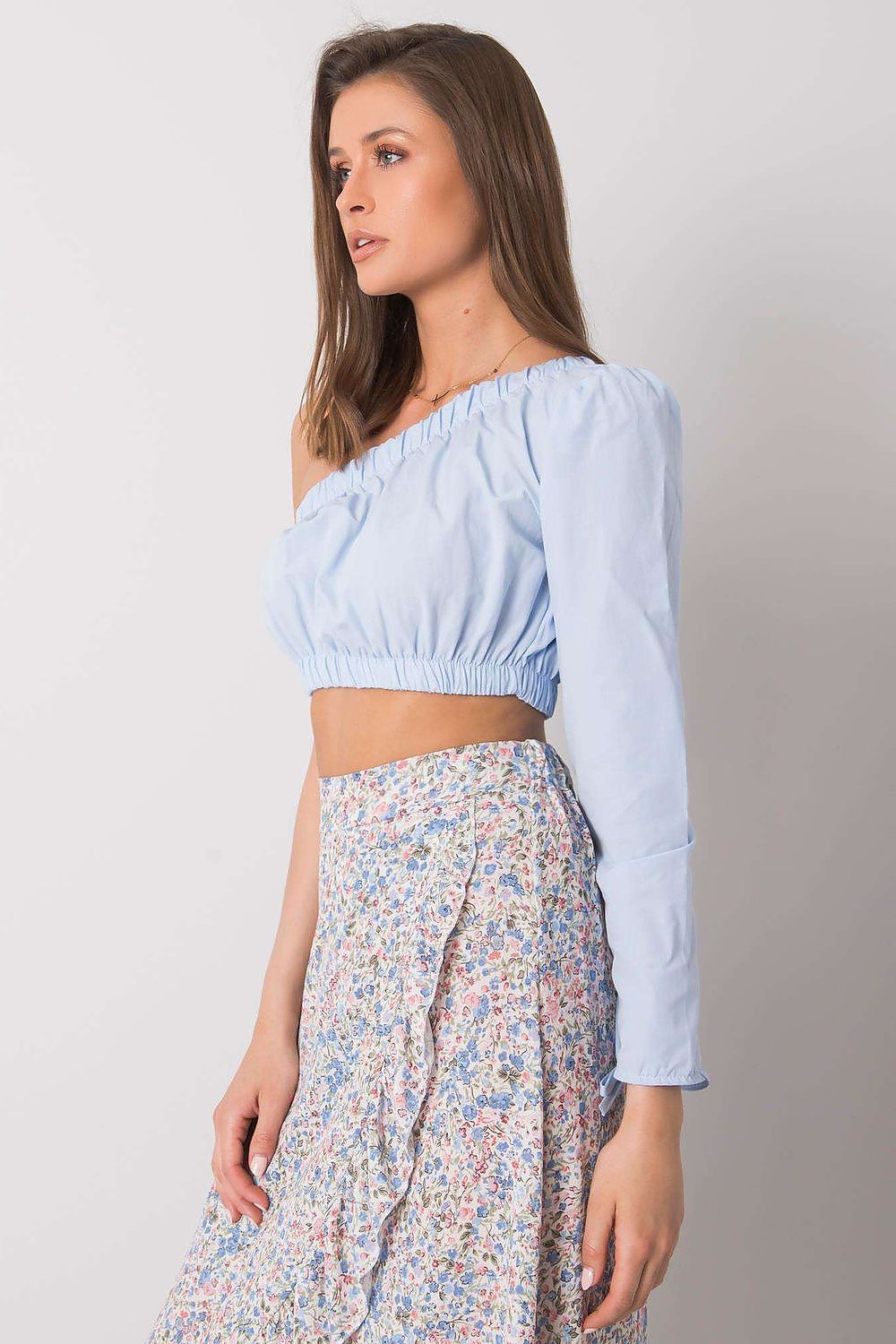 “Blue Asym One-Sleeve Blouse, side view showing cropped fit”