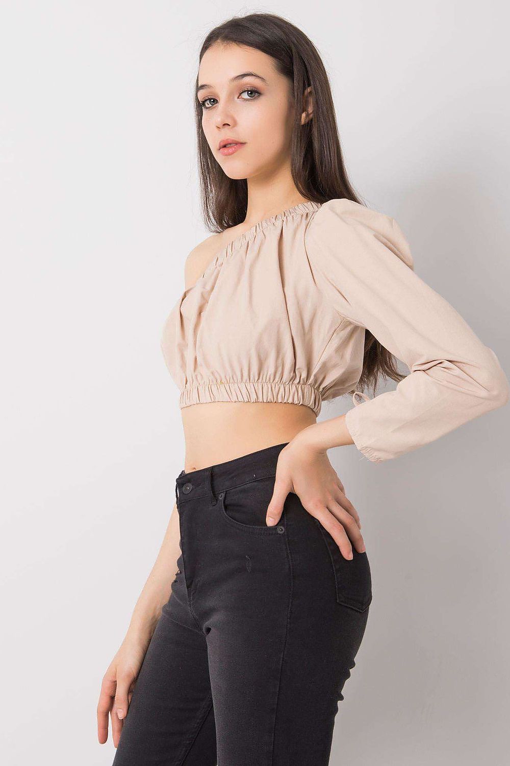 “Beige Asym One-Sleeve Blouse, side view showing cropped silhouette”