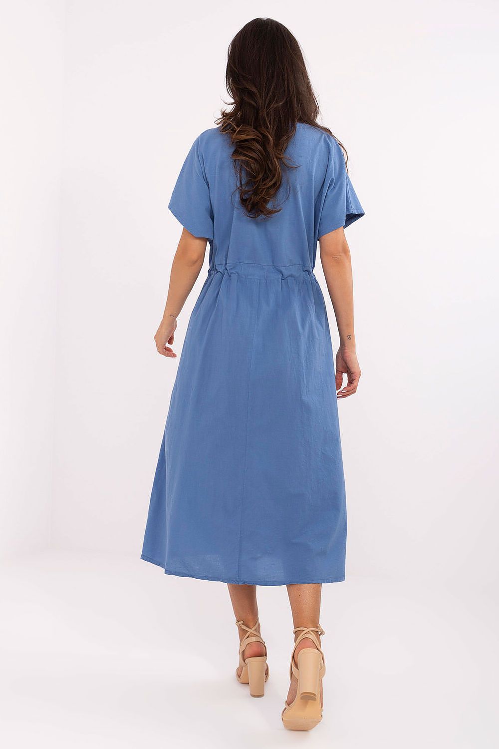Woman wearing a blue dress on a white background