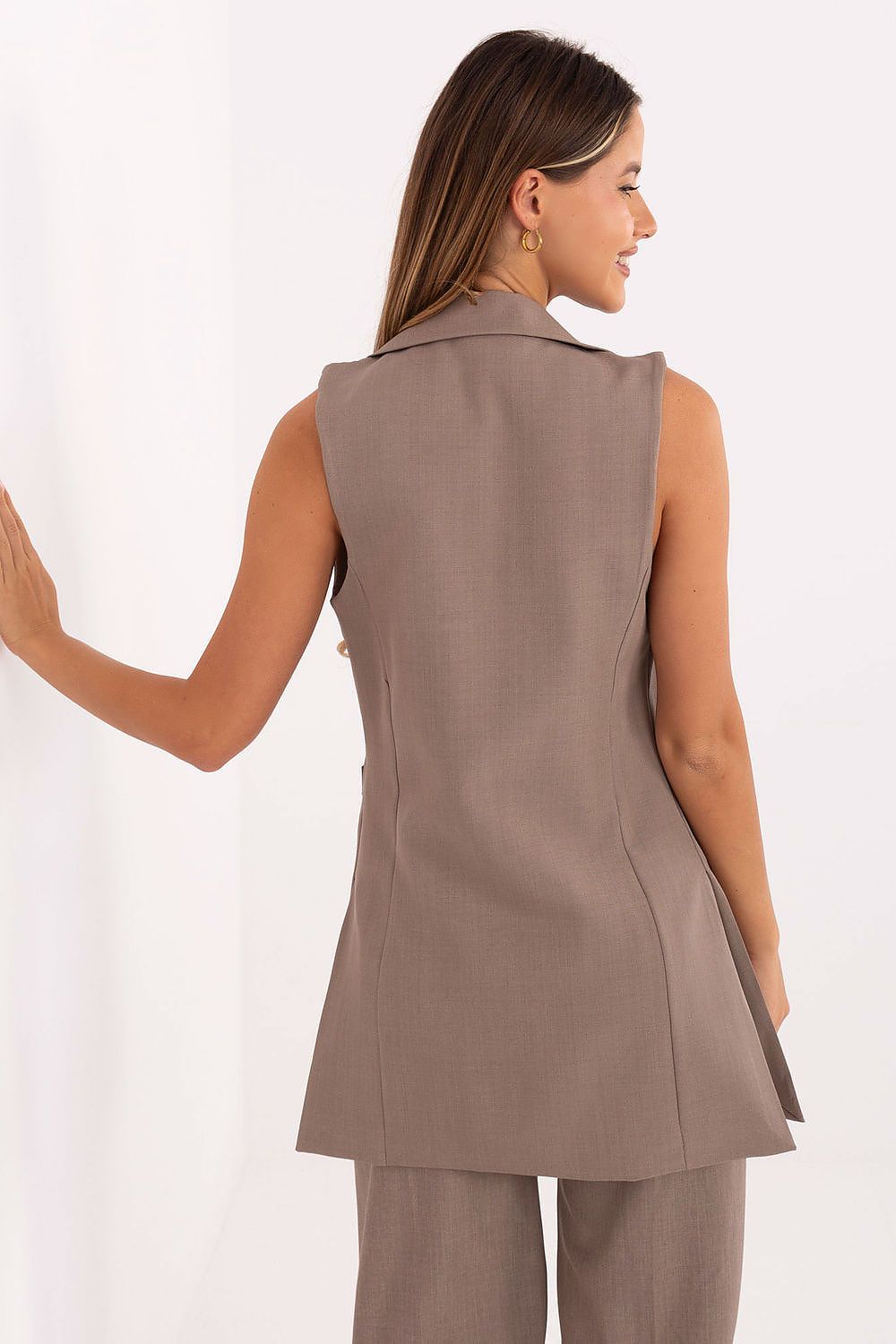 Back view of beige sleeveless women’s gilet showing structured fit.