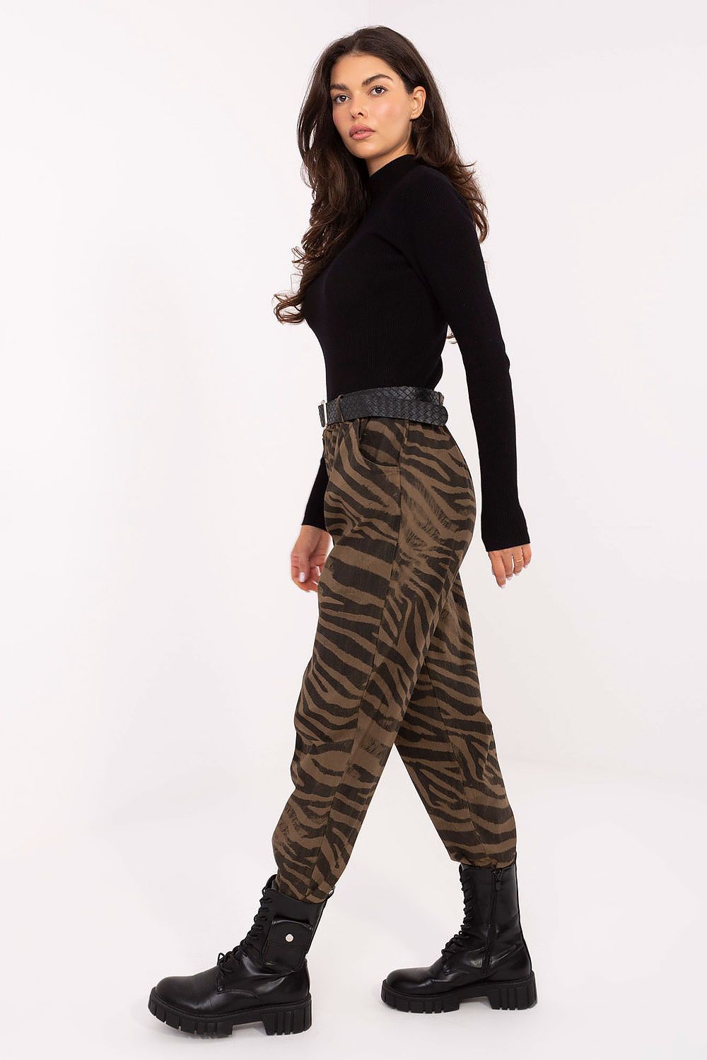 Side view highlighting elastic waistband, belt detail, and bold zebra pattern.