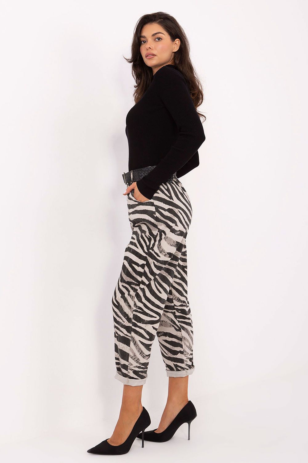 Side view highlighting elastic waistband, side pockets, and bold zebra pattern.