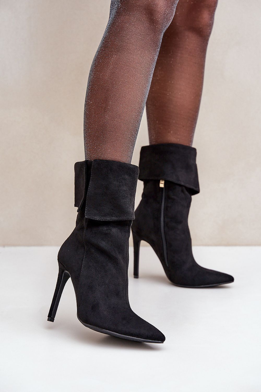 Side view: Side view highlighting turned-down shaft and slender stiletto heel of Sophia ankle boots.
