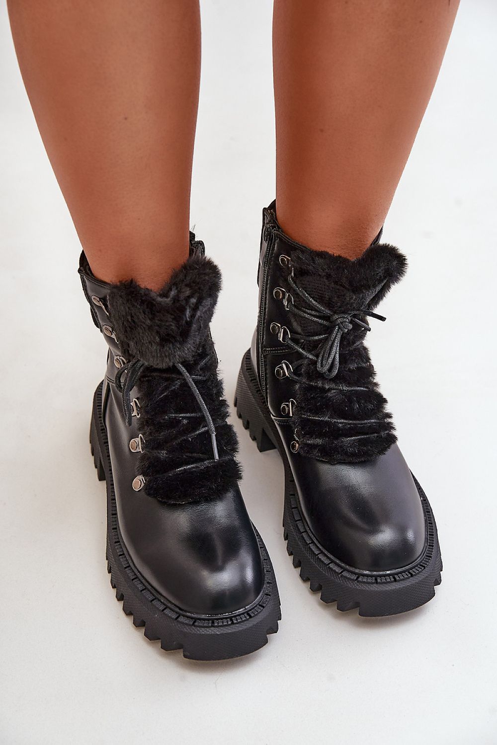 Front view of black women's eco leather ankle boots with fur tongue
