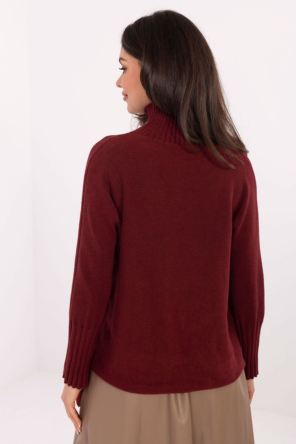 Elegant women’s knit sweater styled with trousers in red