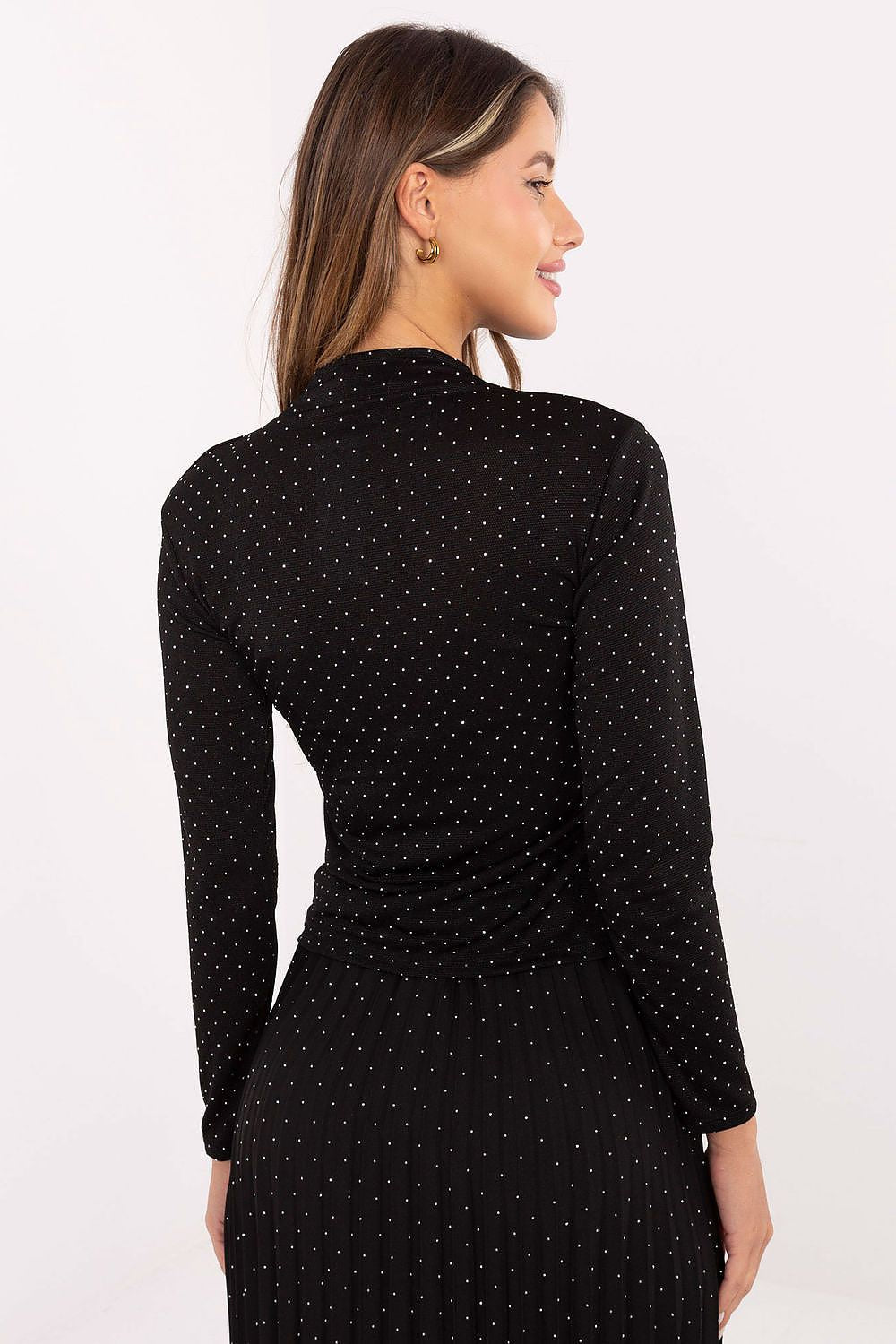 Subtle sequin women’s top paired with elegant trousers in black