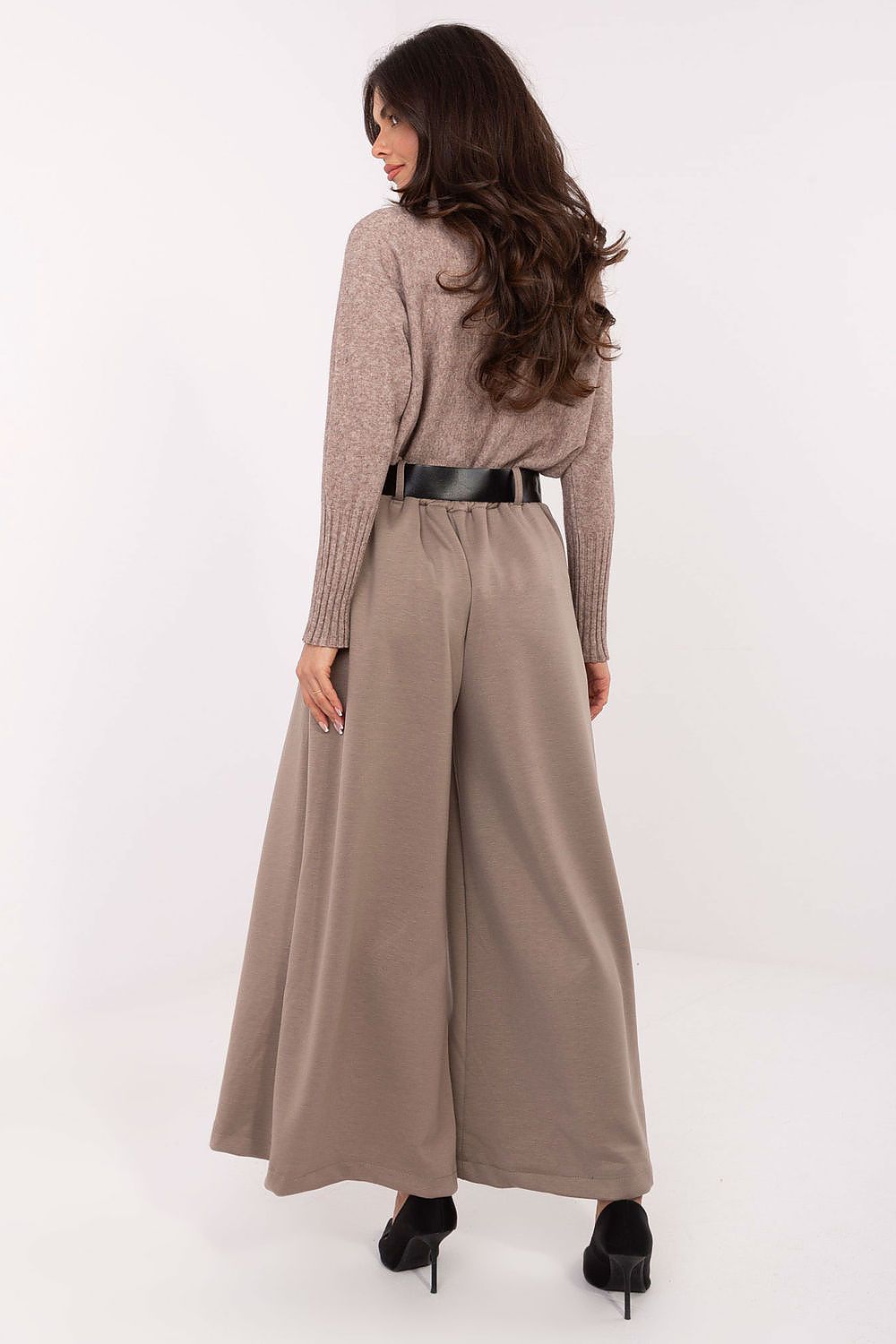 Back close-up of waistline with fastened belt and decorative pleats.