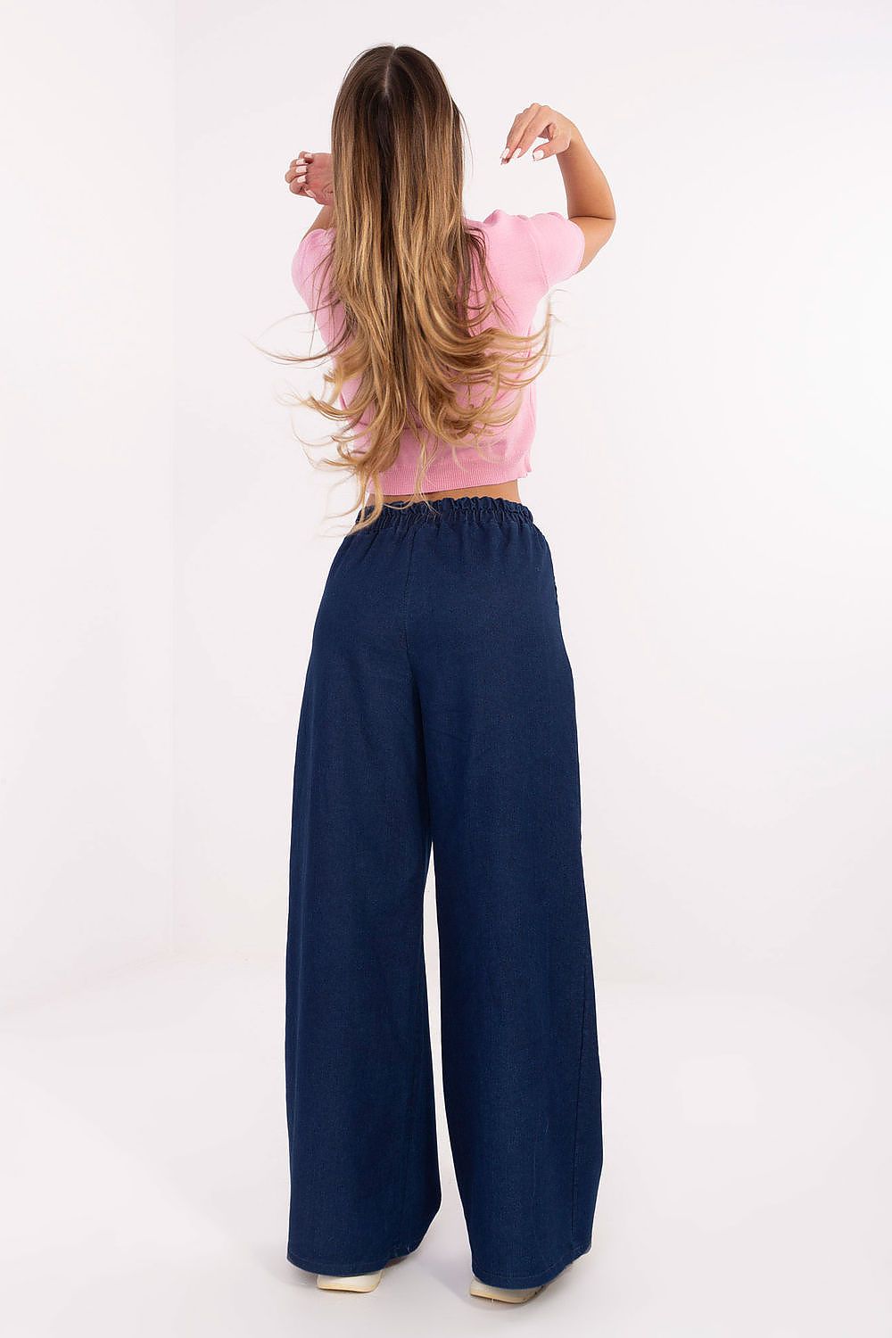 Back view of high waist wide leg jeans in smooth, minimalist denim.