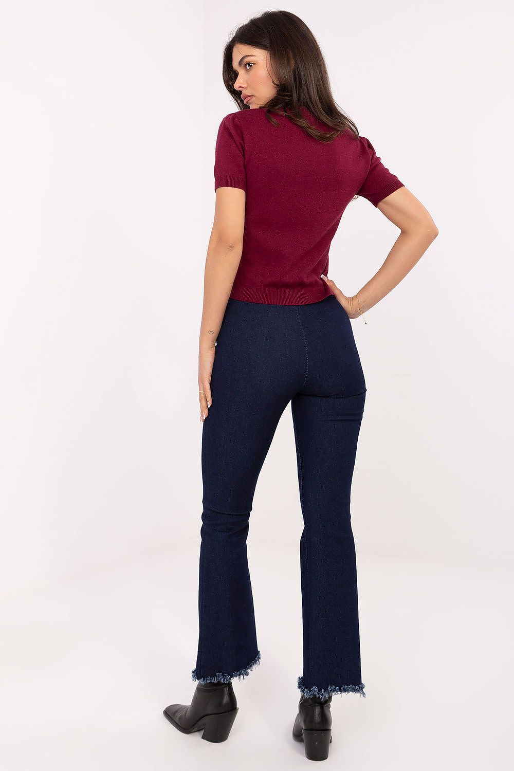 Back view of flared jeans showing elastic waistband and smooth design.