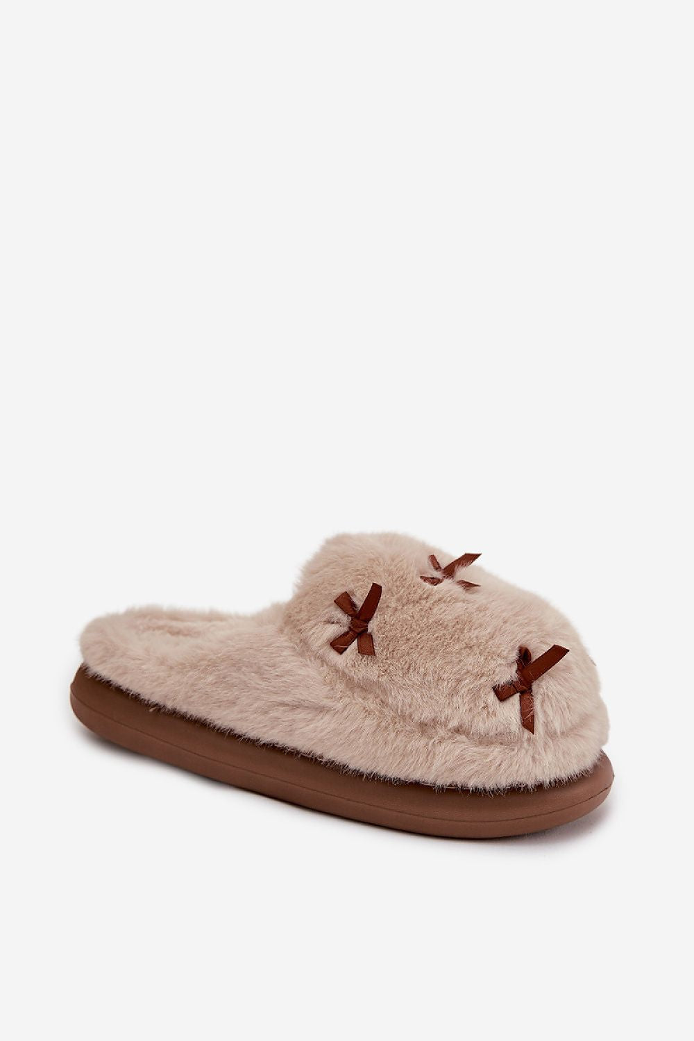 Beige slipper with brown sole and decorative bows on a white background