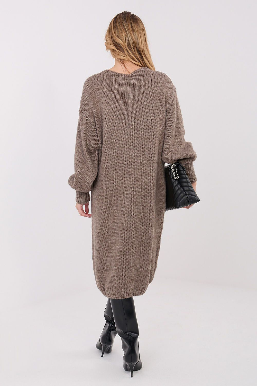 Woman wearing a long brown cardigan on a white background