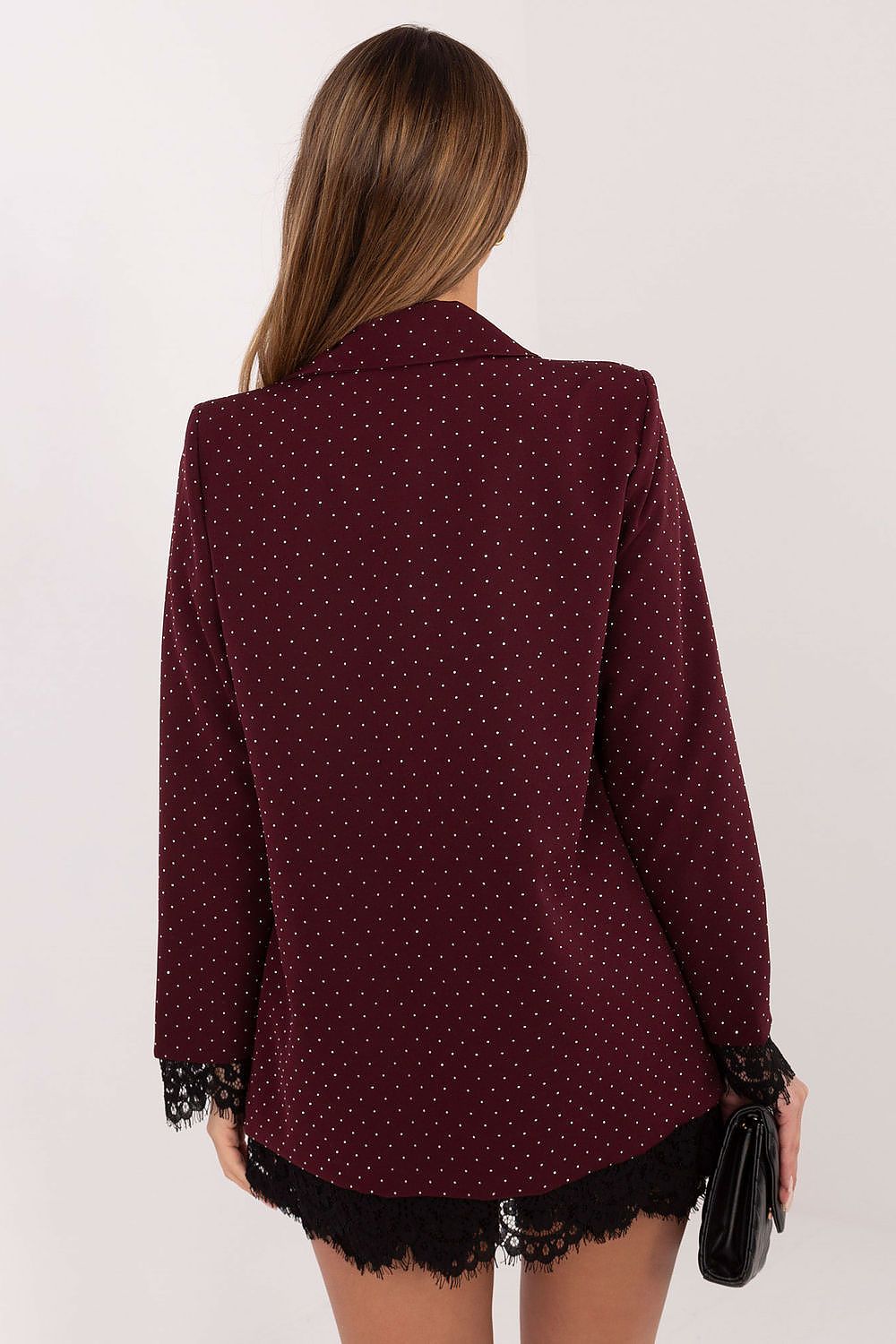 Maroon blazer with lace details worn by a person on a white background