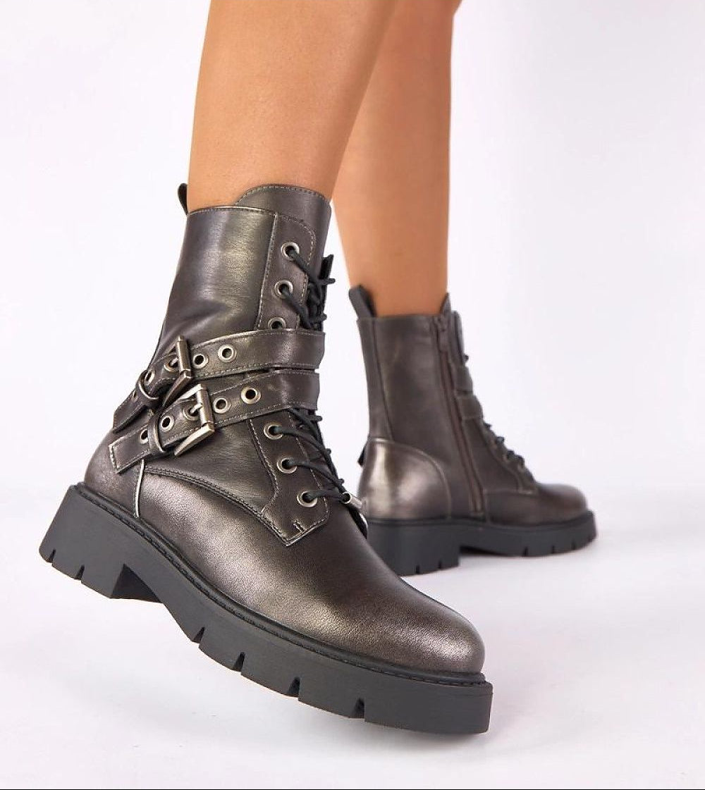 Metallic silver boots with buckles on a white background