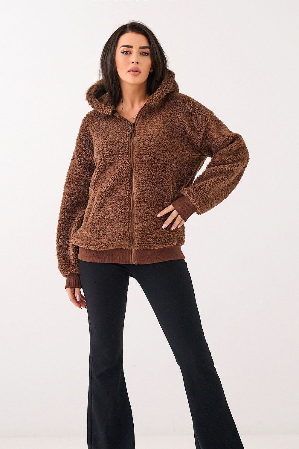 Woman wearing a brown fleece jacket on a white background