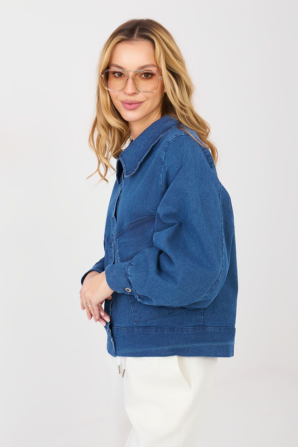 Woman wearing a blue denim jacket on a white background