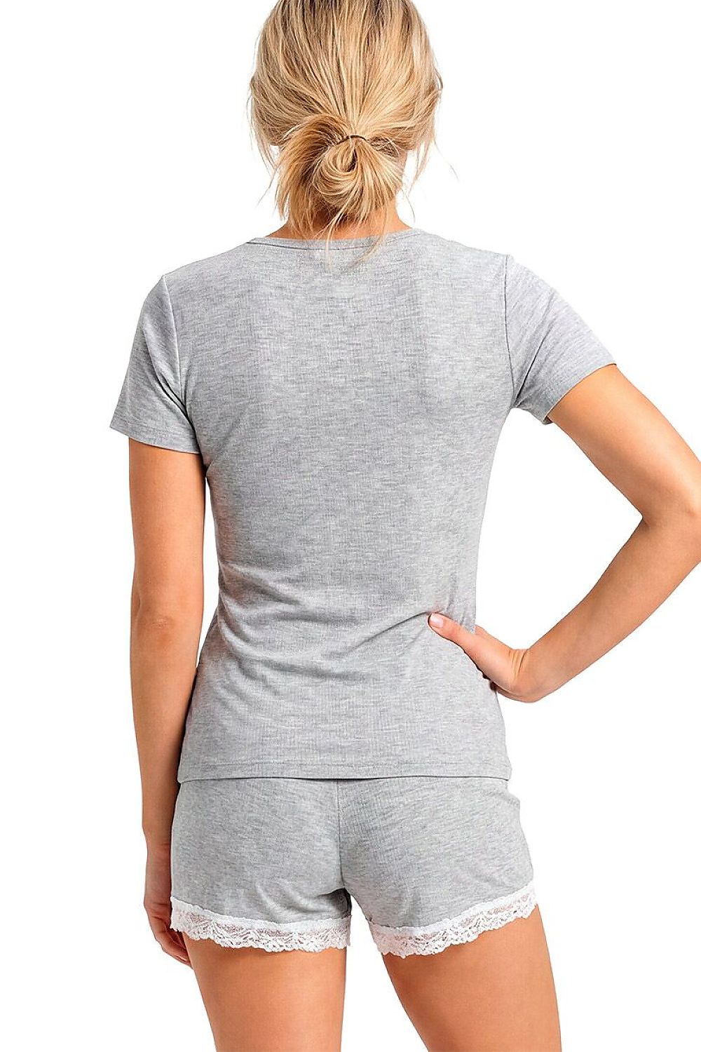 Person wearing a gray pajama set with lace trim on a white background