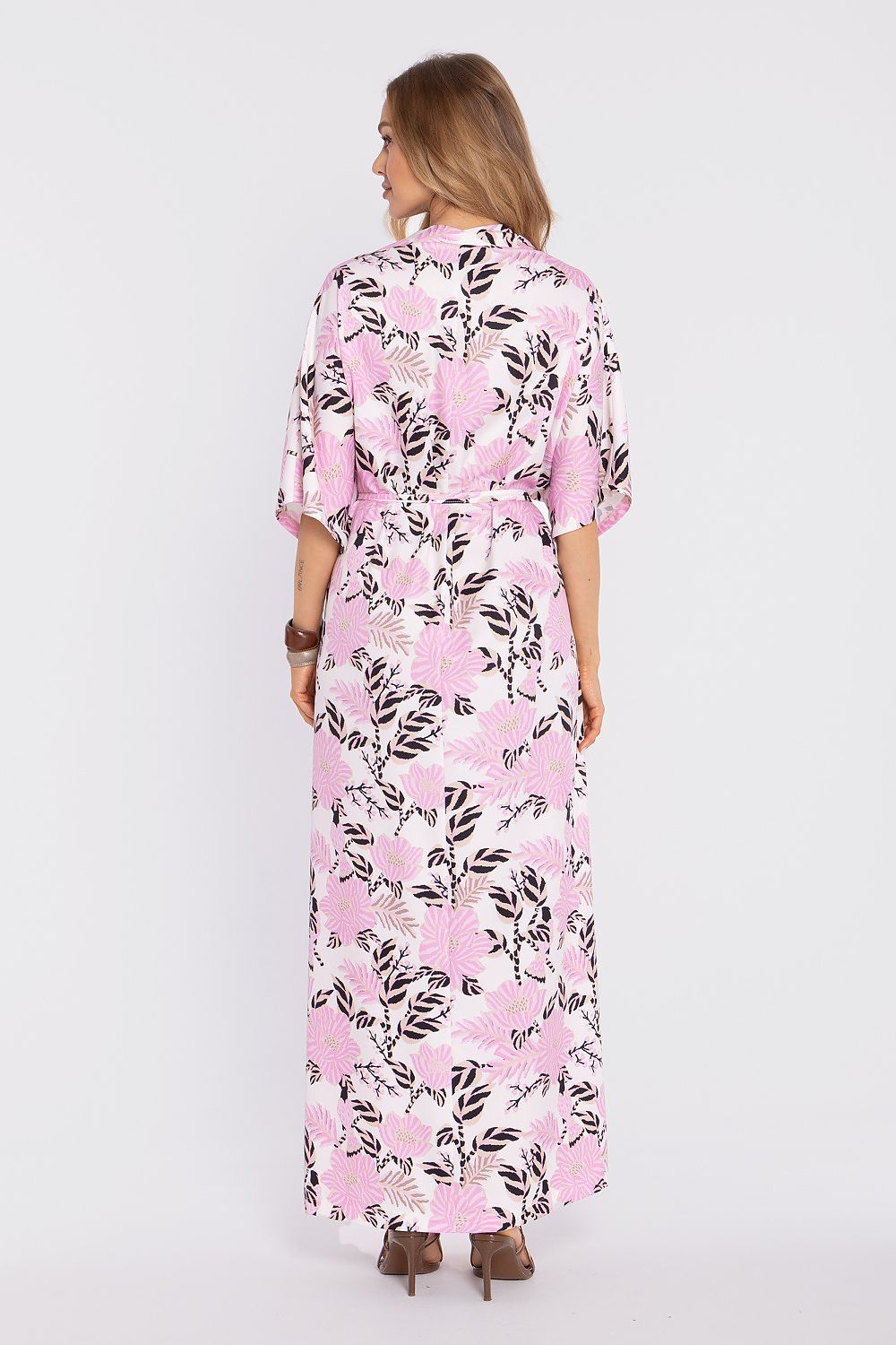 Woman wearing a pink floral dress on a white background