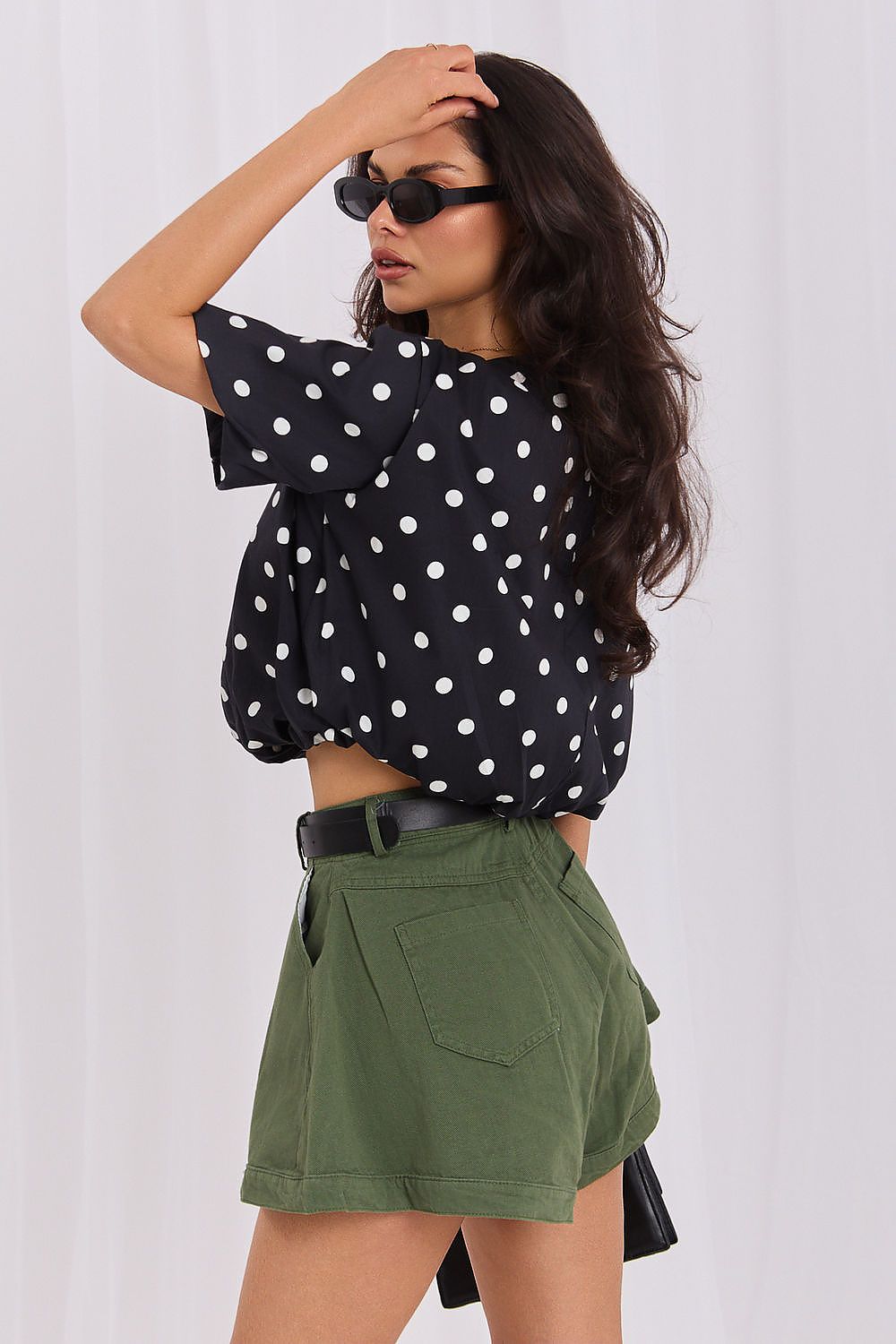 Black polka dot blouse with flattering cropped fit and classic round neckline-rear-view