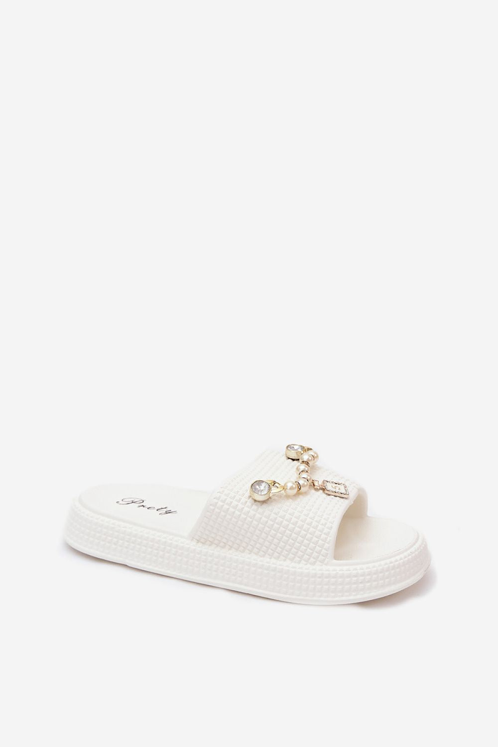 A single white slide sandal with a textured upper strap and a decorative gold-tone chain embellishment with clear rhinestones, shown against a plain white background.