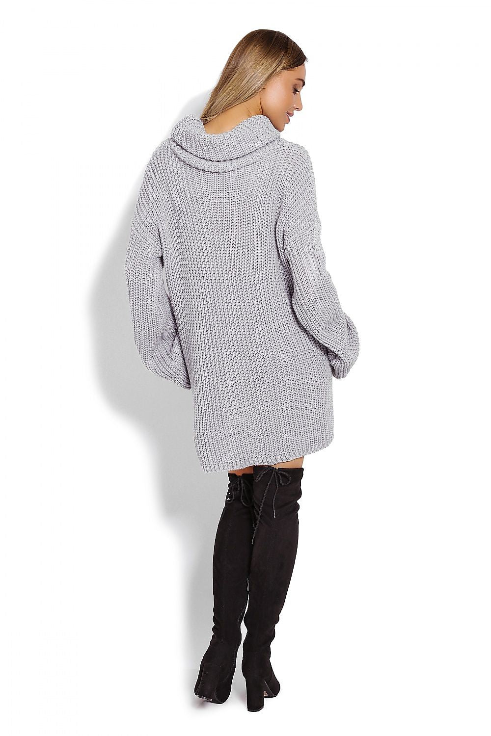 Person wearing a gray oversized sweater and black knee-high boots on a white background