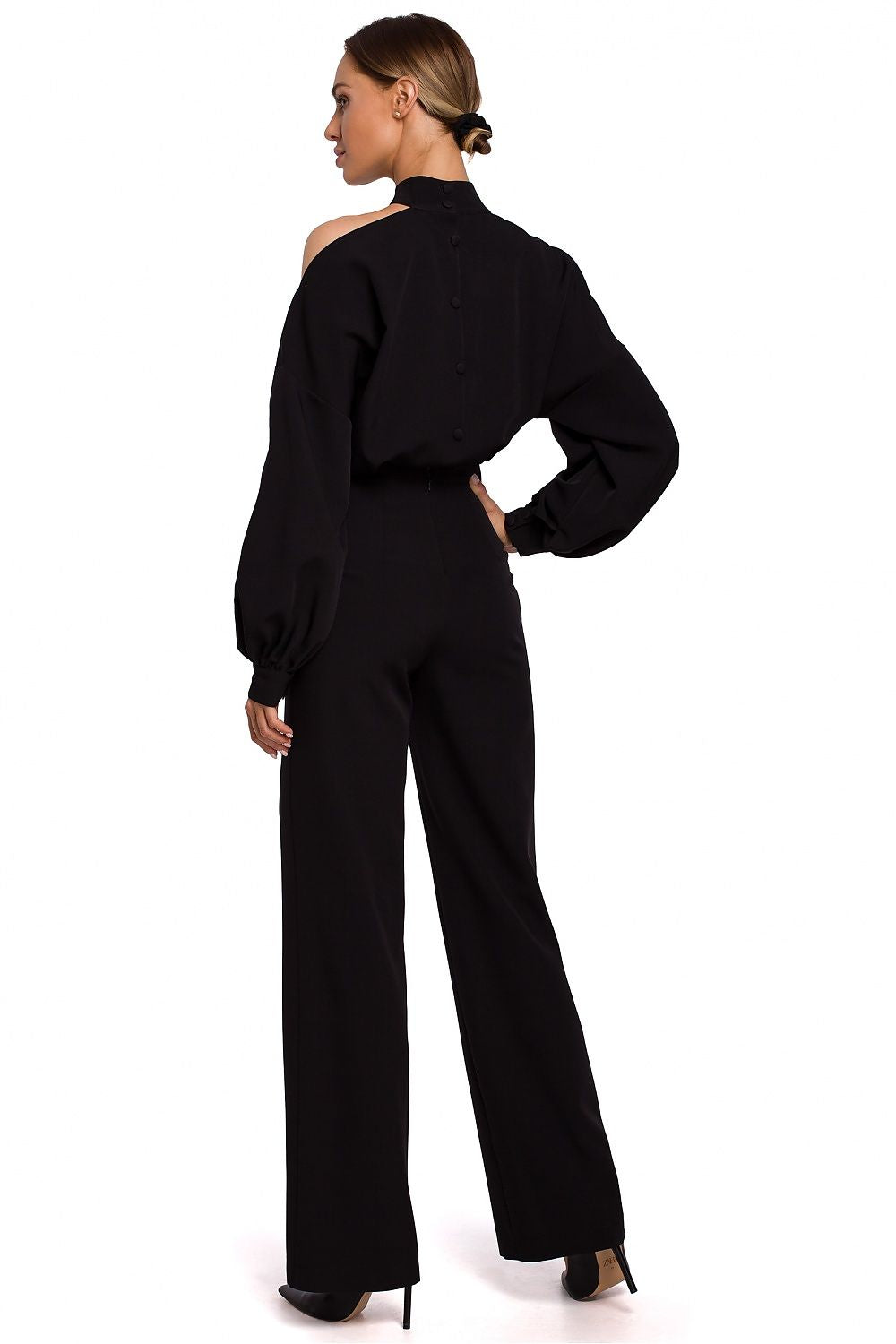 Person wearing a black outfit with wide-leg pants on a white background