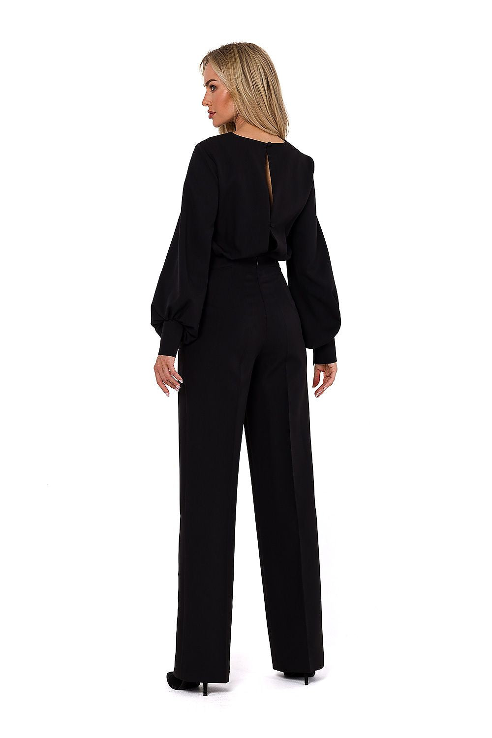 Woman wearing a black jumpsuit on a white background