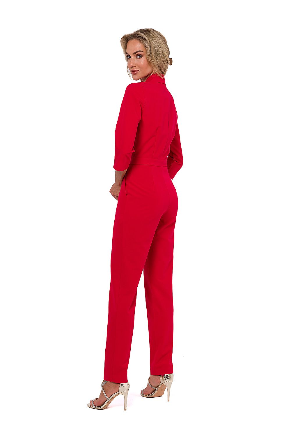 Woman wearing a red jumpsuit on a white background