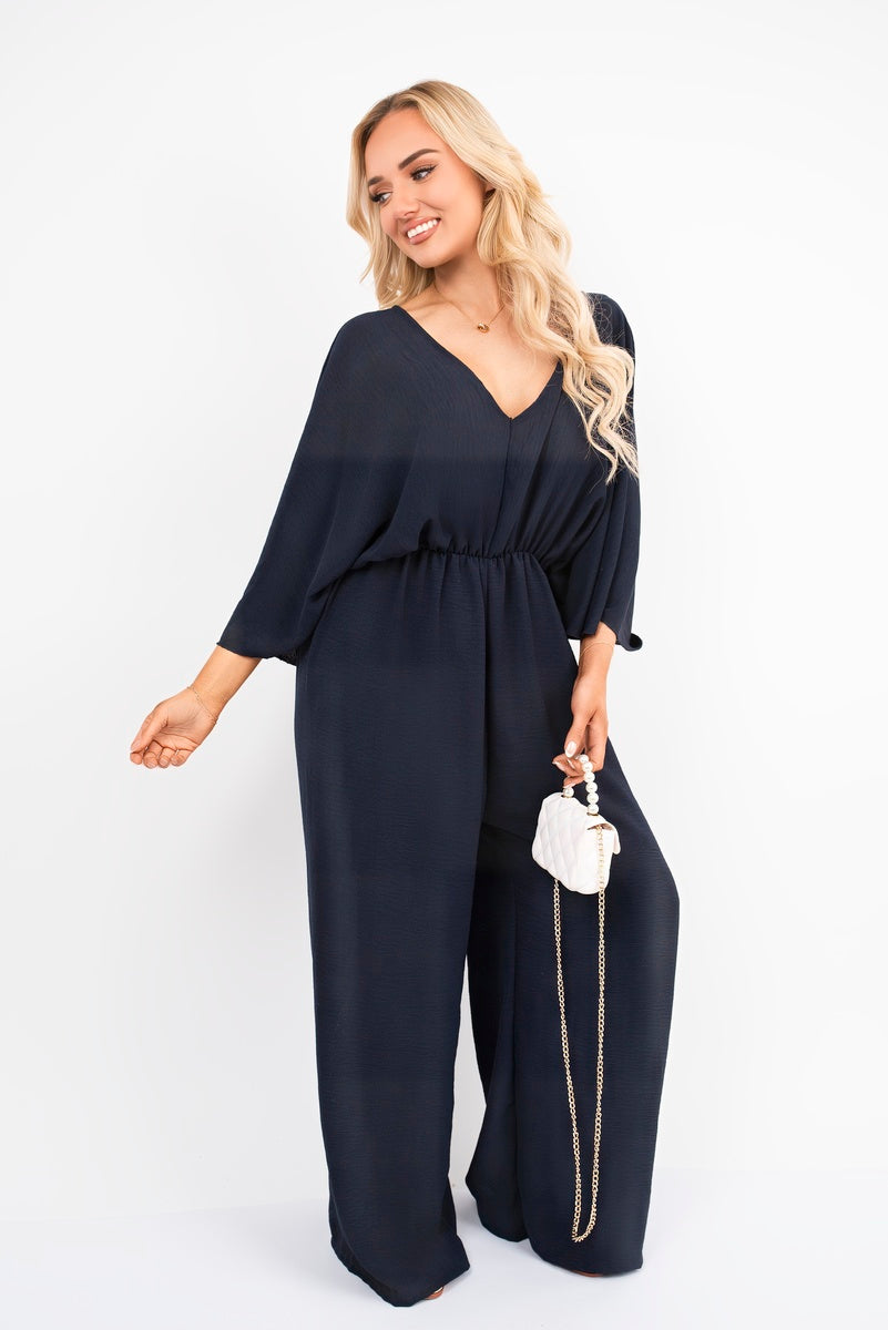 Navy: “Wide leg V-neck jumpsuit in navy with back tie detail, front view”