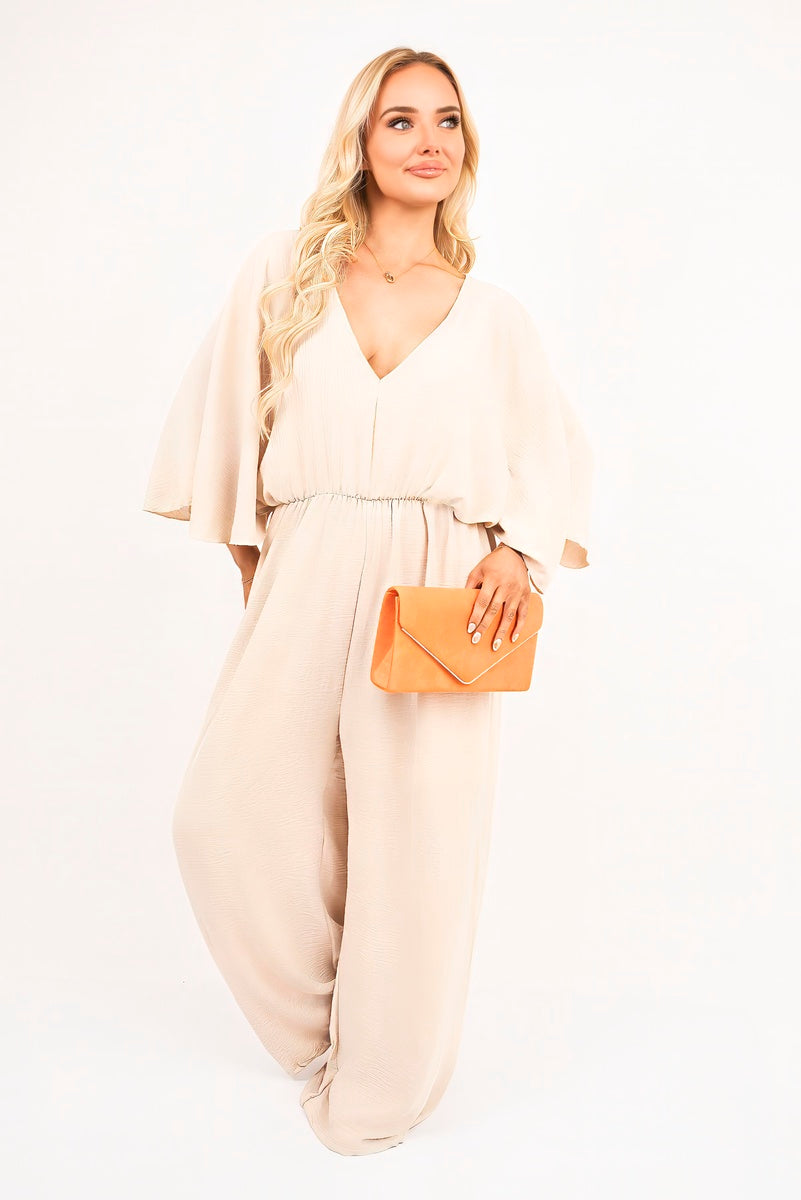 Beige: “Wide leg V-neck jumpsuit in beige with back tie detail, front view”