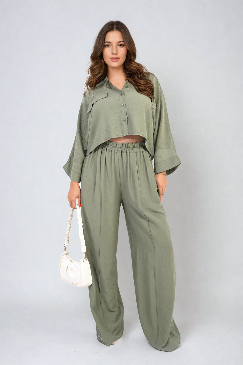 Woman wearing a green outfit with a white background