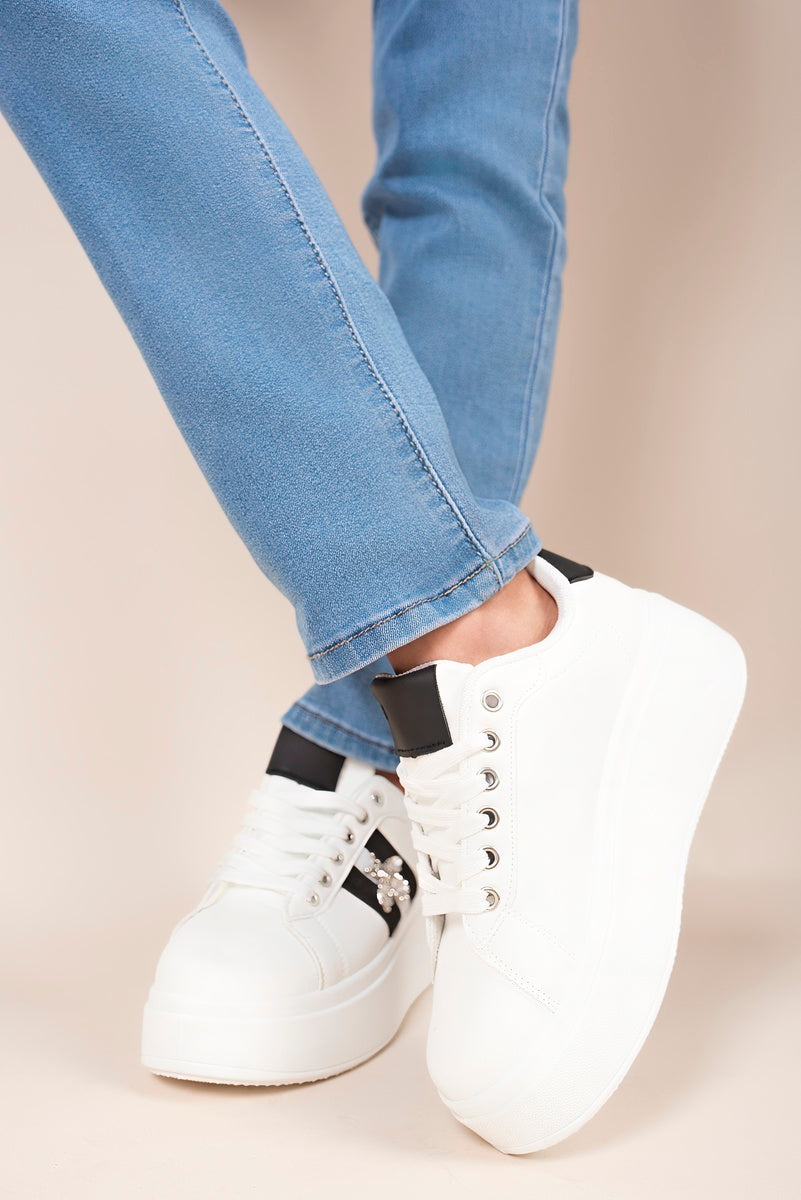 “White chunky glitter trainers with bee charm, top view”