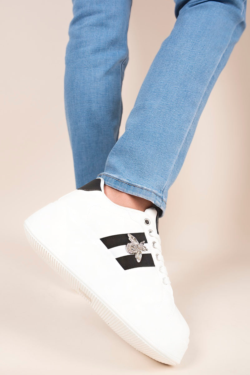 “White chunky glitter trainers with bee charm, back view”