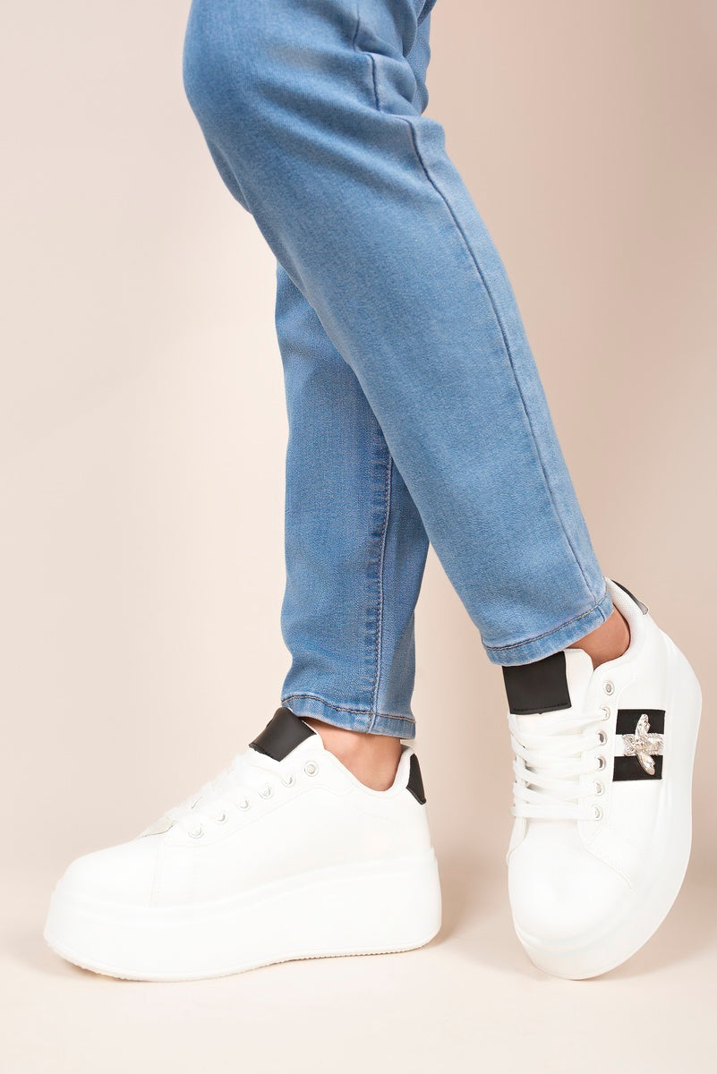 “White chunky glitter trainers with bee charm, front view”
