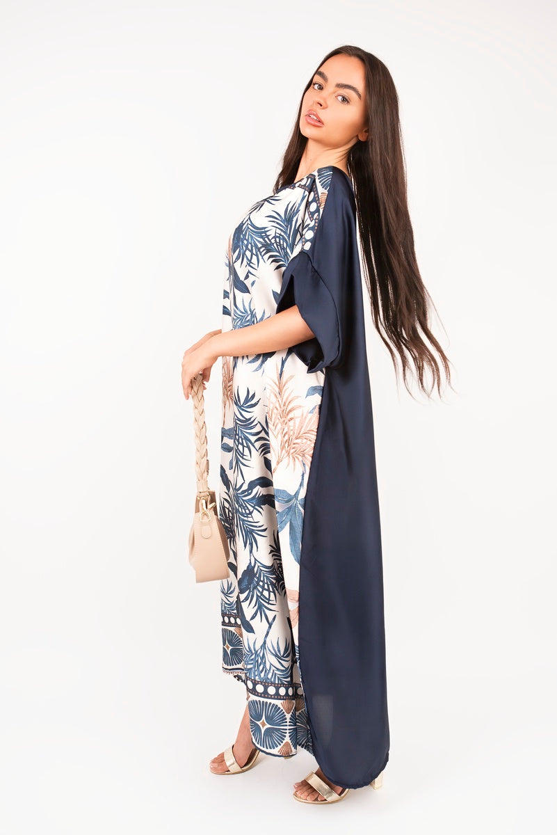 “Navy oversized batwing maxi dress with tropical print, side view”