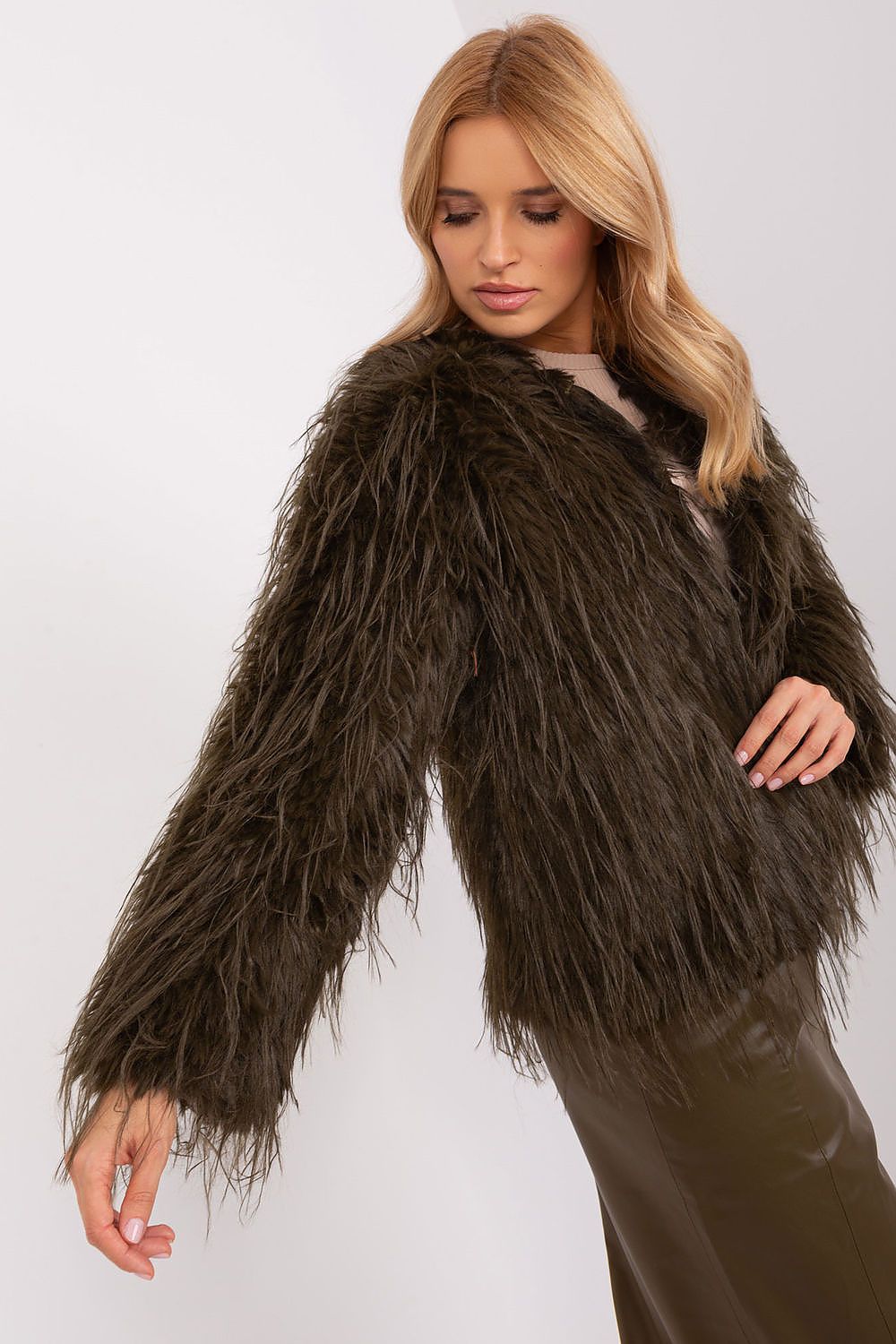 Woman wearing a brown shaggy jacket on a white background