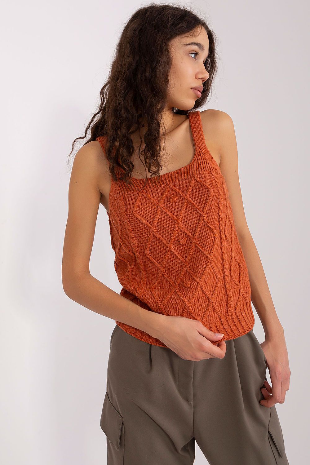 Close-up of textured fabric and sleeve detail in orange