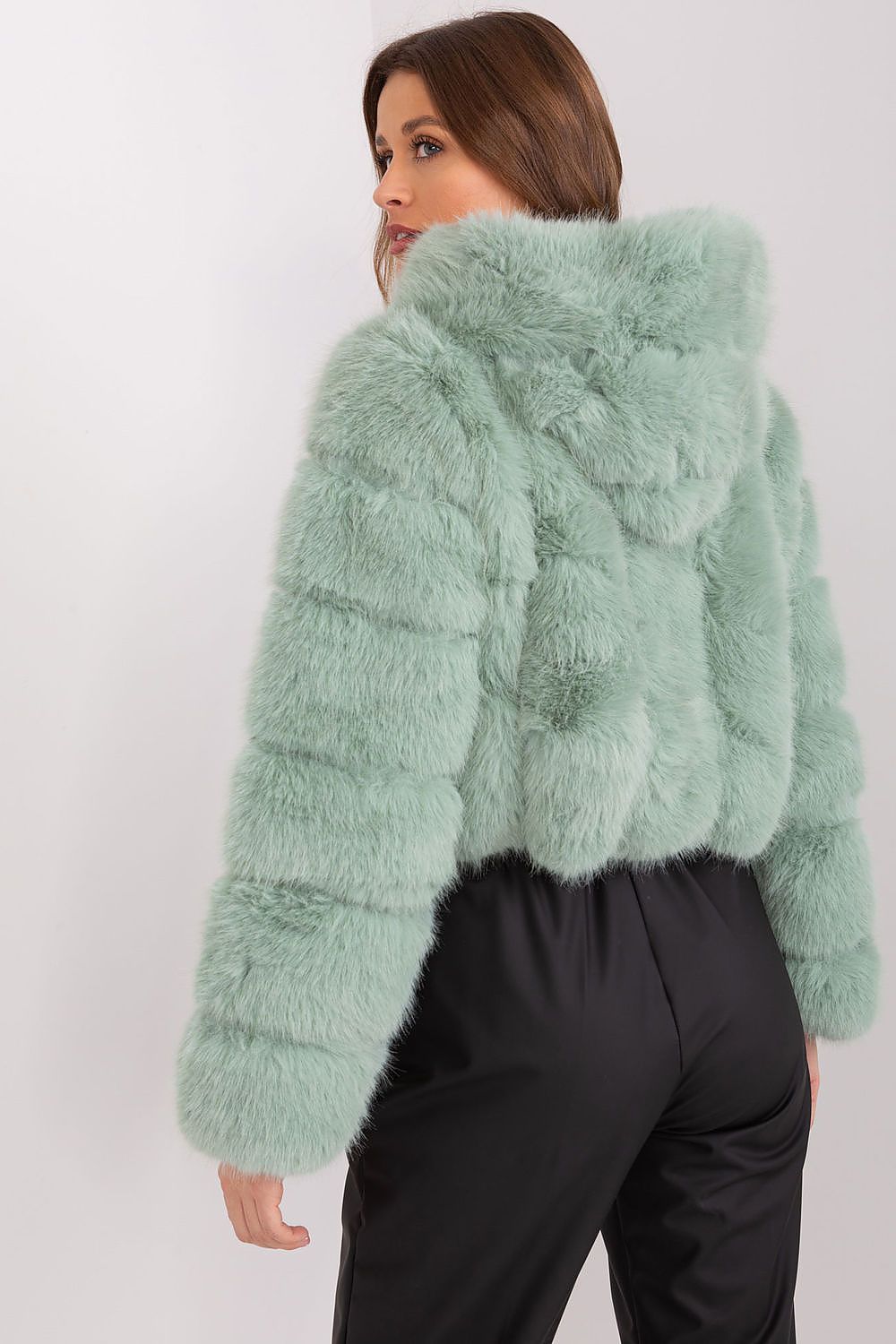 Green faux fur hooded jacket styled for an elegant casual outfit rear view