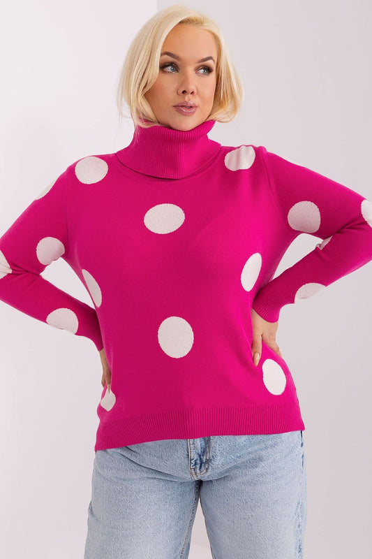 Pink women’s turtleneck sweater with large white polka dots.