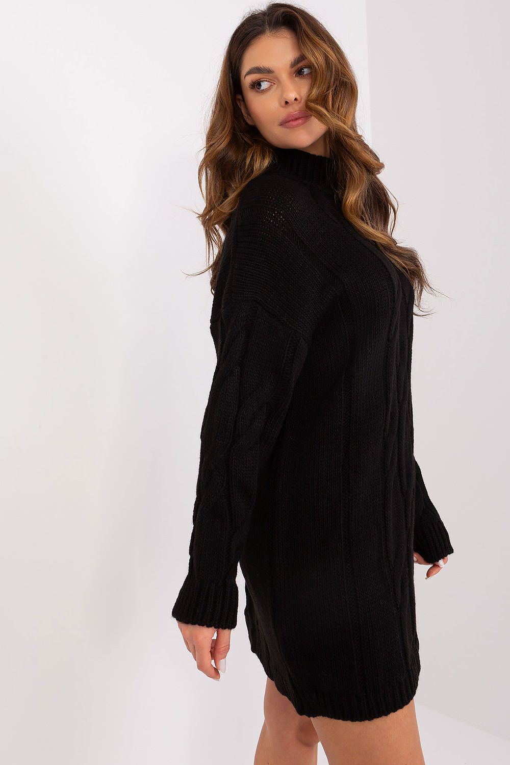 Side view of black variegated dress showing slim fit and knee-length cut.