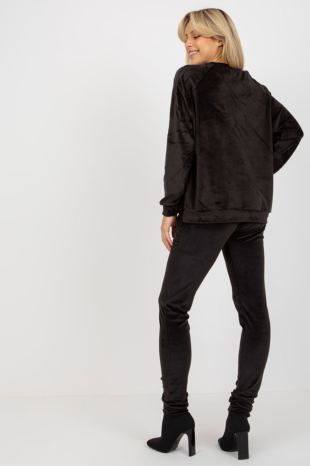 Woman wearing a black outfit on a white background