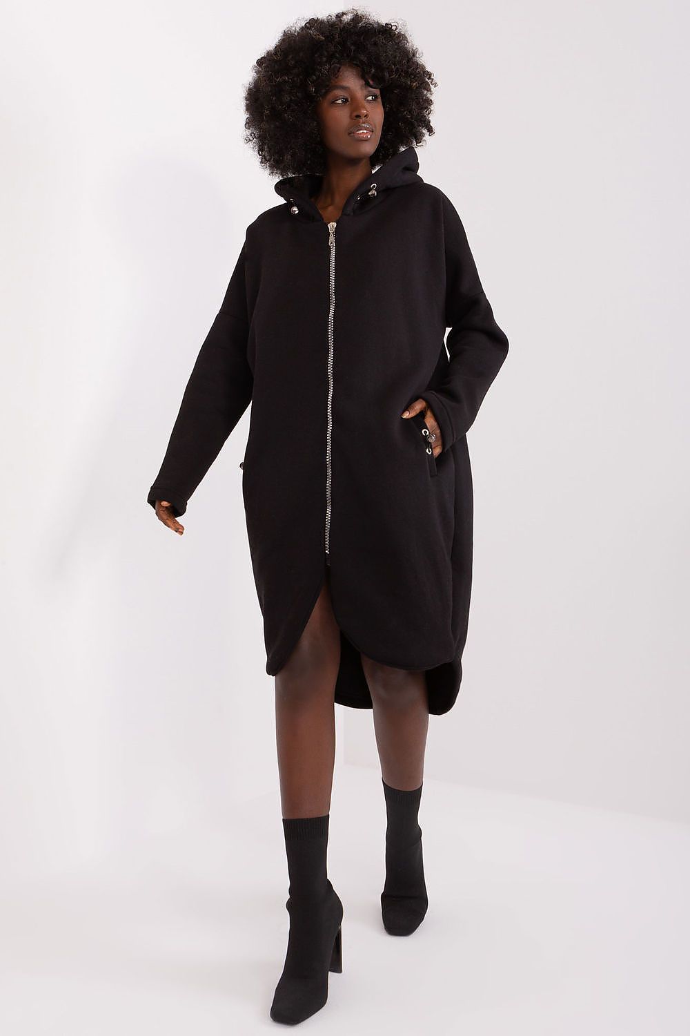 Person wearing a black coat on a white background