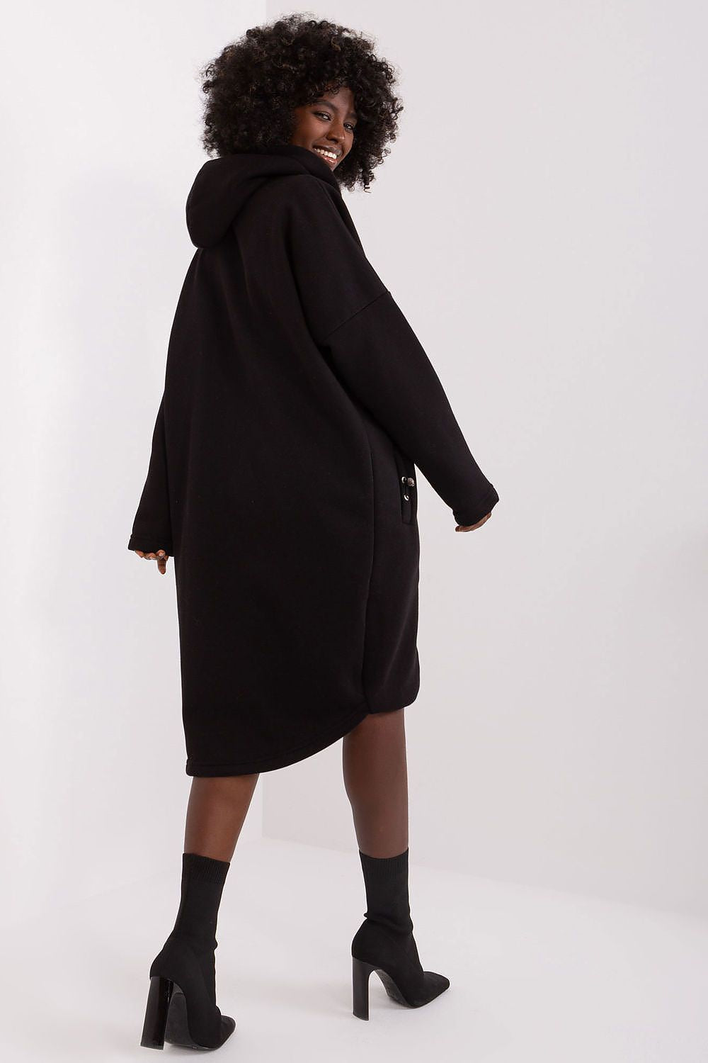 Person wearing a black coat on a white background