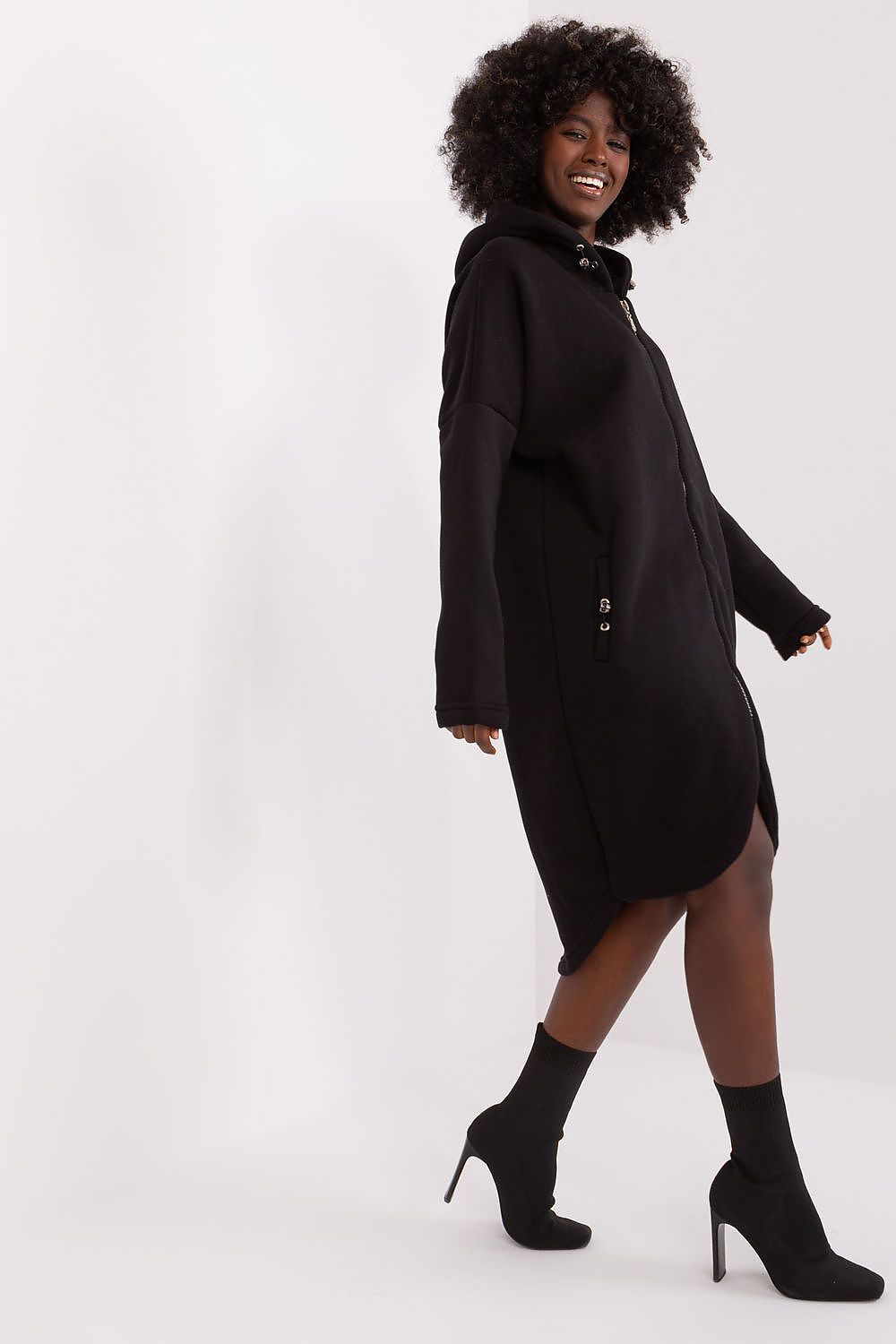 Woman wearing a black dress with a white background