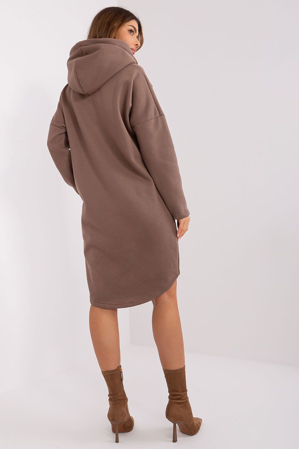 Woman wearing a brown hooded coat on a white background
