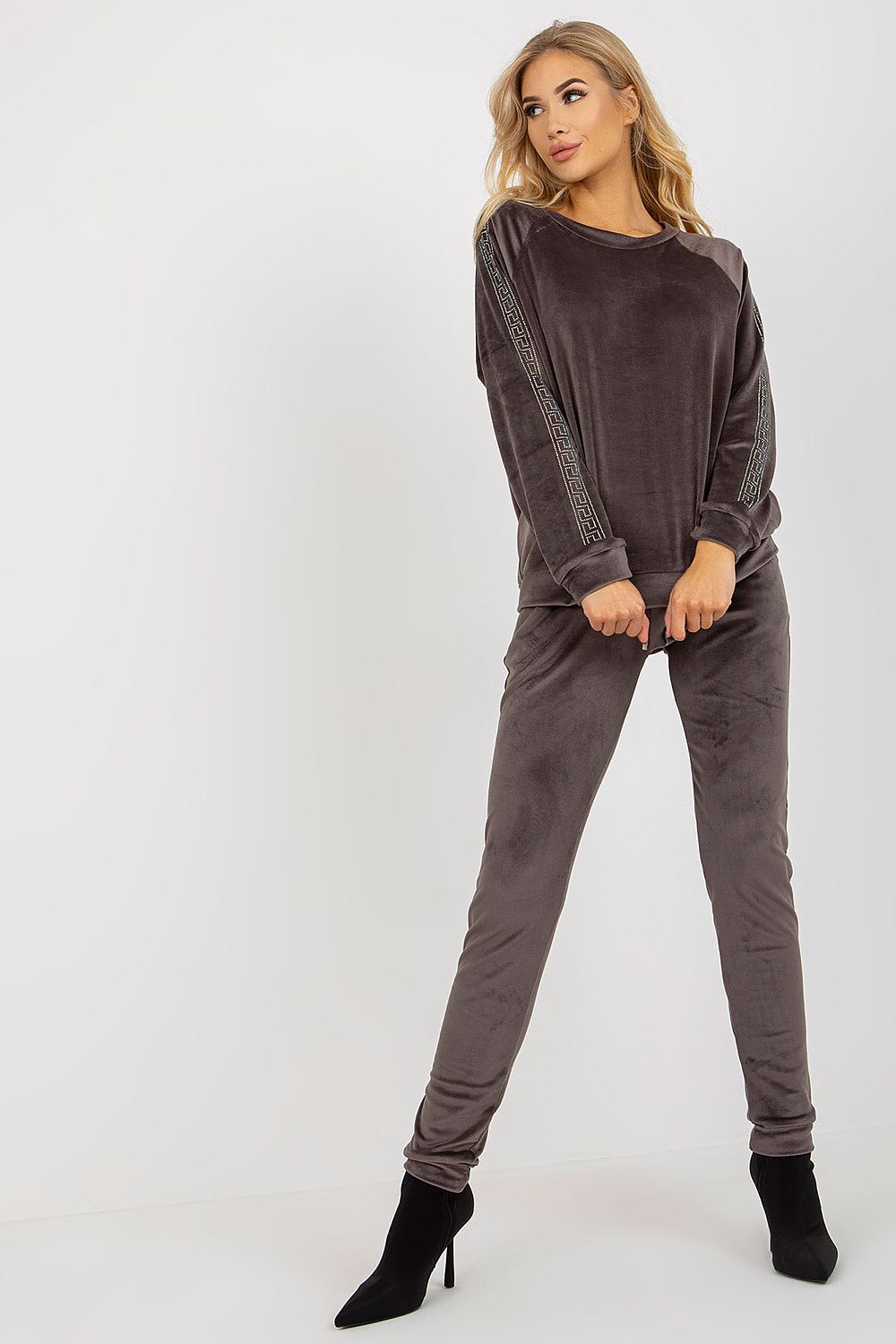 Woman wearing a brown outfit with a white background