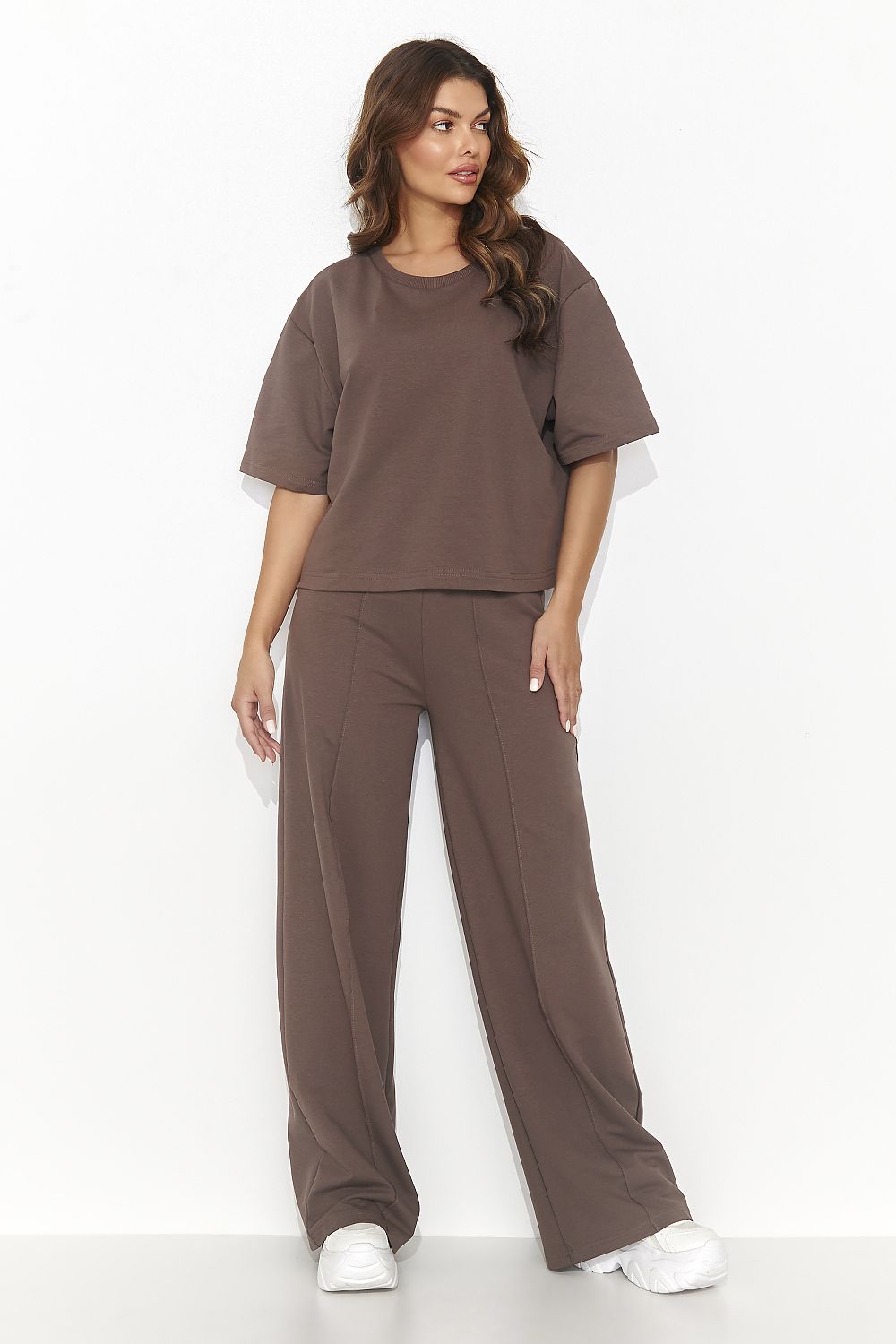 Woman wearing a brown outfit on a white background